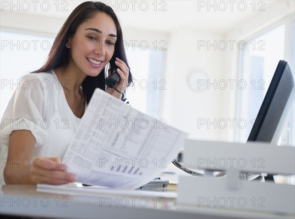 Caucasian businesswoman working at desk