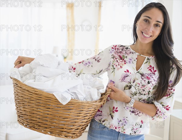 Caucasian woman carrying basket of laundry