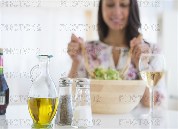 Caucasian woman tossing salad at lunch