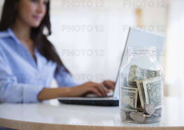 Caucasian businesswoman with tip jar