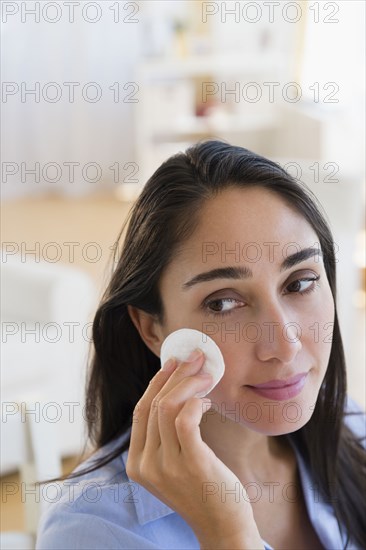 Caucasian businesswoman wiping her face