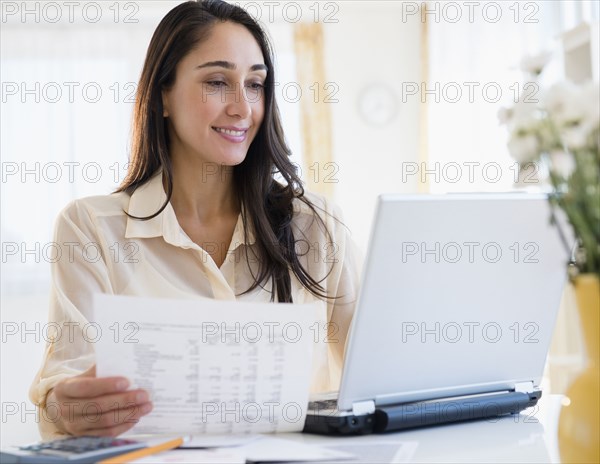 Caucasian businesswoman working at laptop