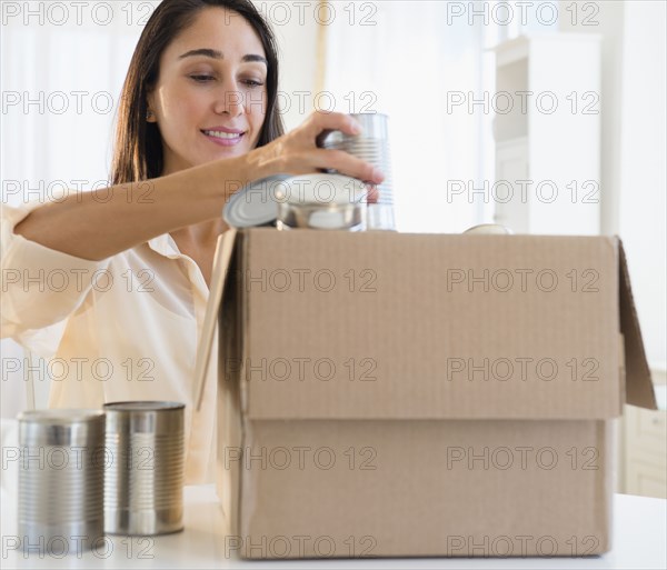 Caucasian woman recycling cans