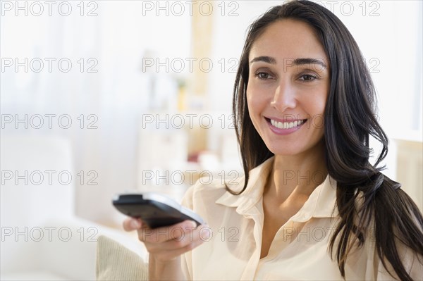Caucasian woman watching television