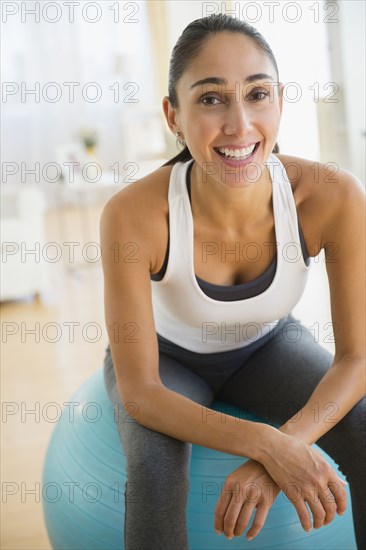 Caucasian woman sitting on exercise ball