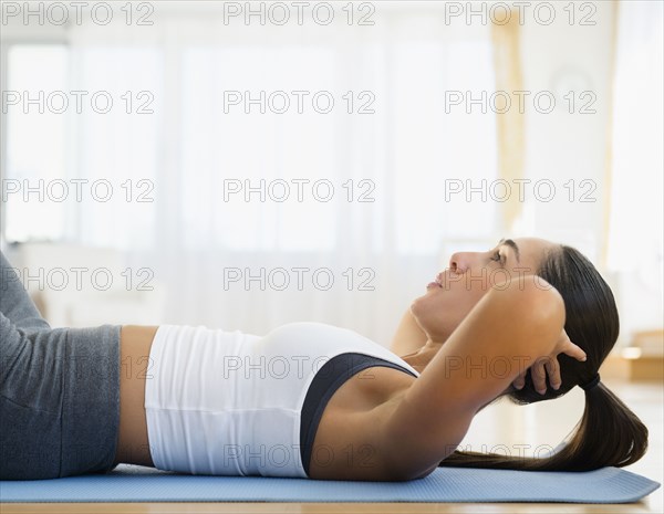 Caucasian woman working out on exercise mat