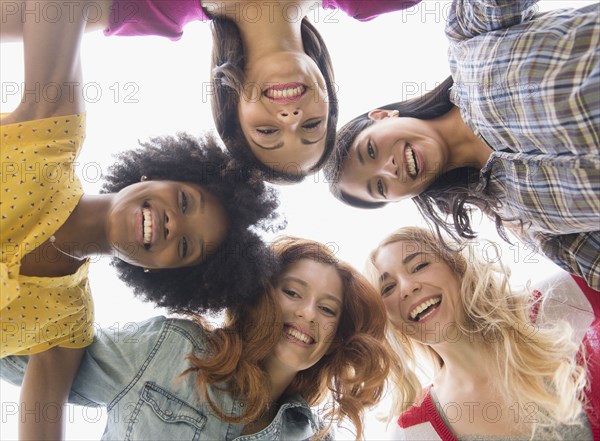 Smiling women standing in circle