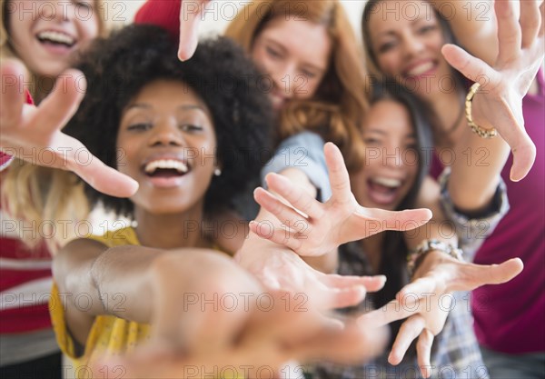 Smiling women reaching forward