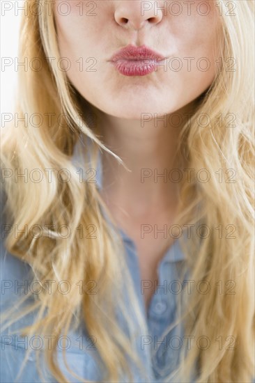 Caucasian woman blowing a kiss