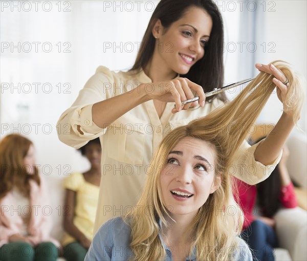 Worried woman having her hair cut