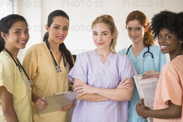 Nurses in colorful scrubs talking in hospital