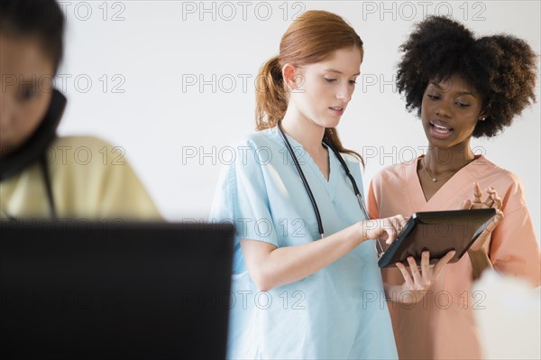 Nurses using tablet computer in hospital