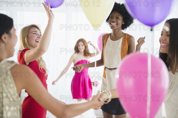 Women playing with balloons at party