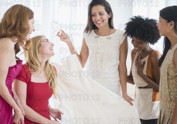 Woman showing off new dress to friends