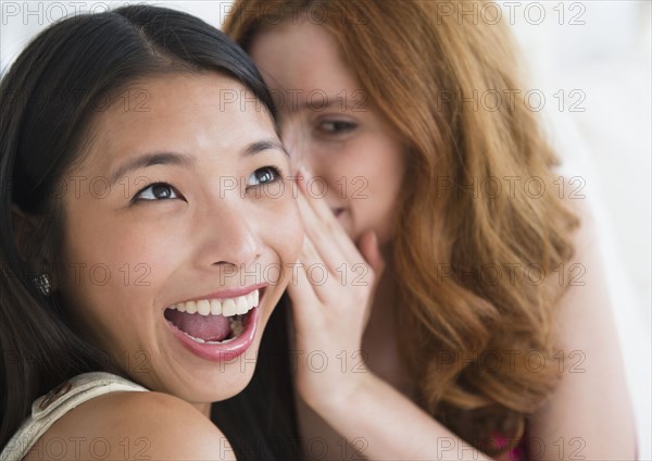 Women whispering to each other