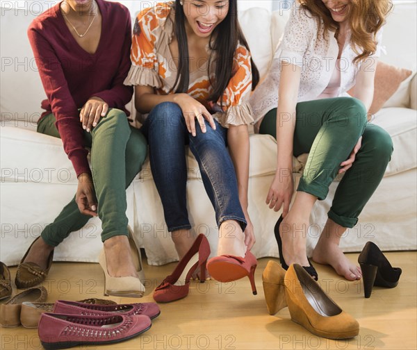 Women trying on shoes together