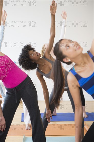 Women practicing yoga in class