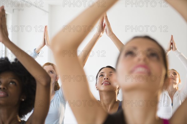 Women practicing yoga in class