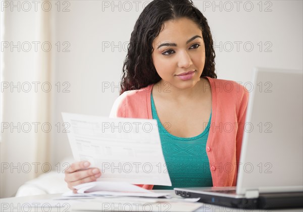 Hispanic woman working on laptop