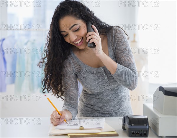 Hispanic woman working in laundromat