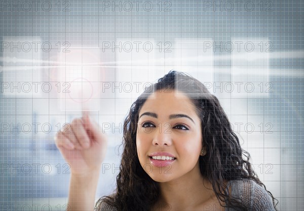 Hispanic woman using touch screen