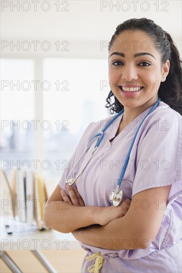 Hispanic nurse smiling in hospital