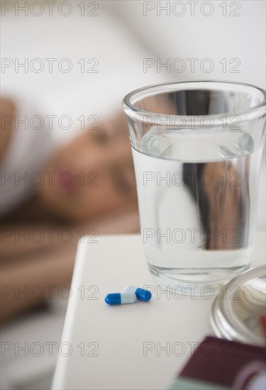 Close up of pills and water on bedside table