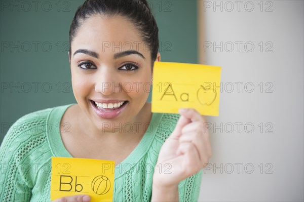 Hispanic teacher using flash cards