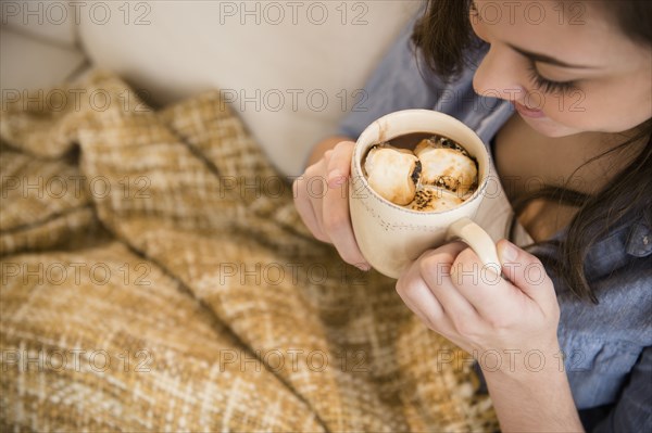 Hispanic girl drinking hot chocolate