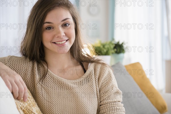 Hispanic girl sitting on couch