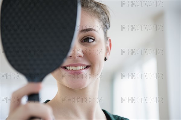 Hispanic girl admiring herself in mirror