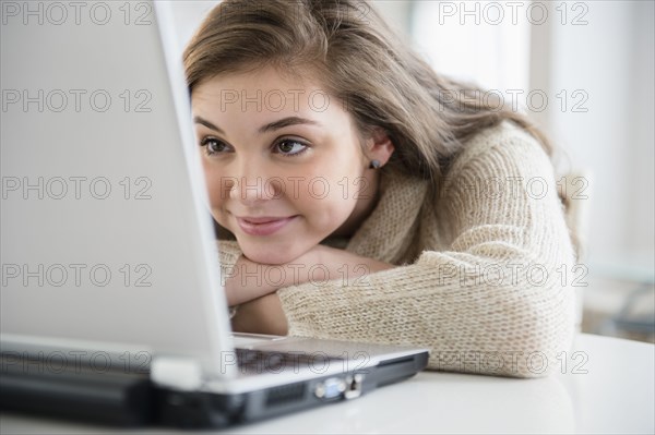 Hispanic girl using laptop at desk