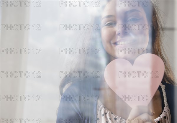Hispanic girl holding heart