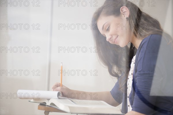 Hispanic girl studying at desk
