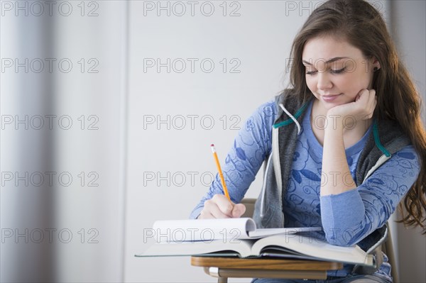 Hispanic girl studying at desk