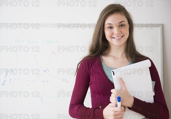 Hispanic girl holding notepad