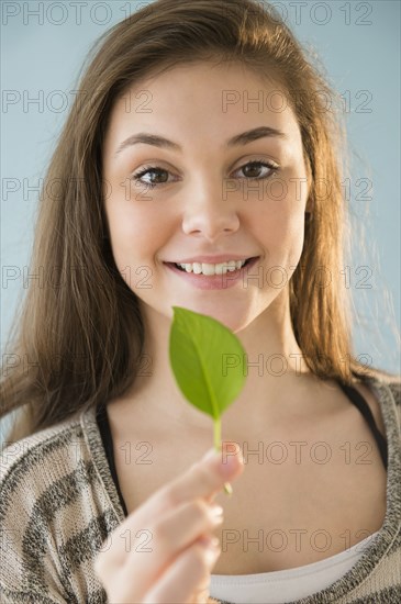 Hispanic girl holding leaf