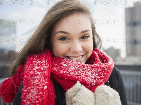 Hispanic girl wearing scarf in snow
