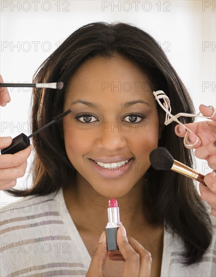 African American woman having makeup applied