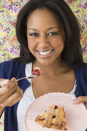 African American woman eating dessert