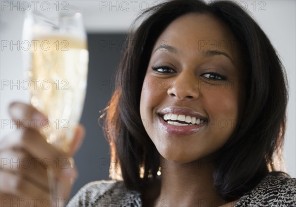 African American woman drinking champagne