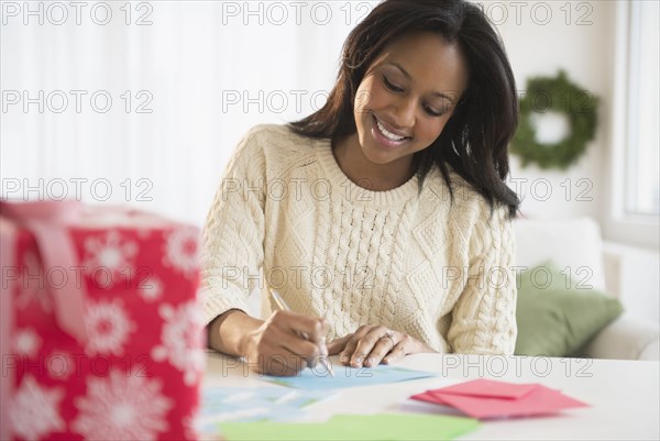African American woman writing at desk