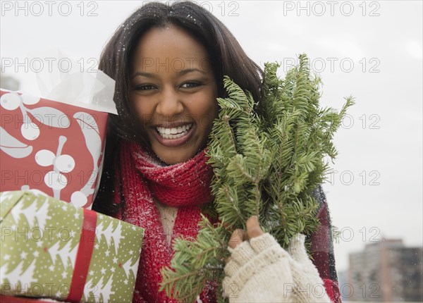 African American woman carrying Christmas presents