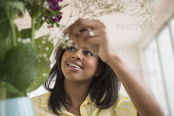 African American woman arranging flowers