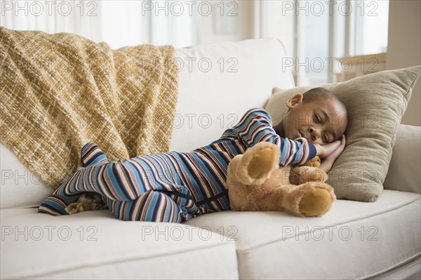 African American boy napping on sofa