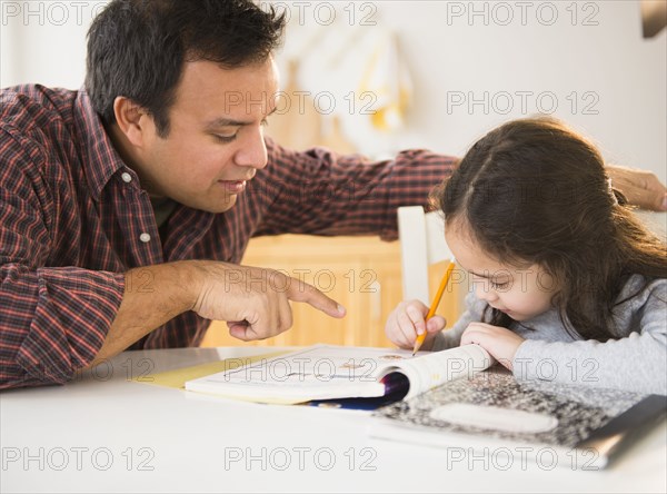 Father helping daughter with homework