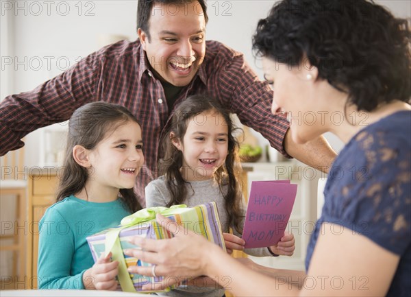 Smiling family celebrating girl's birthday