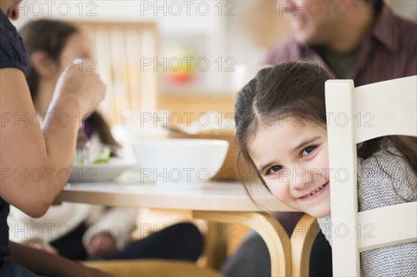 Smiling girl sitting at table