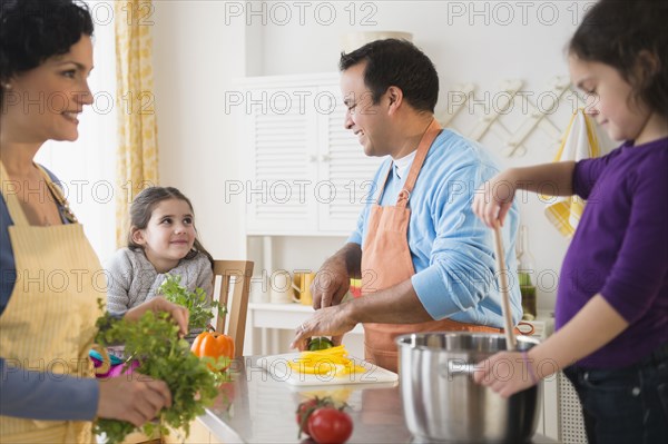 Family cooking together in kitchen