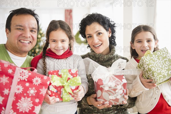 Family holding Christmas presents